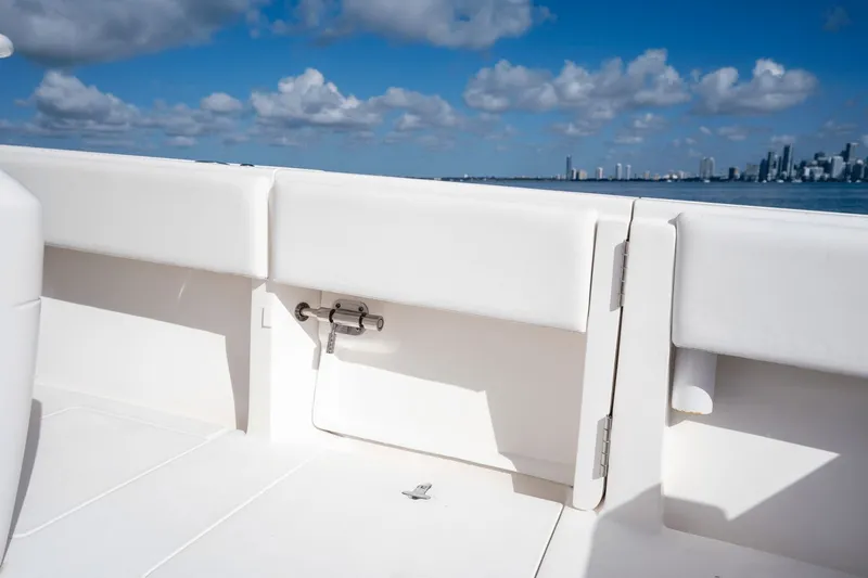 Slide: The Image of 2015 Intrepid 327 CC boat interior with ocean and city skyline in background. - 27