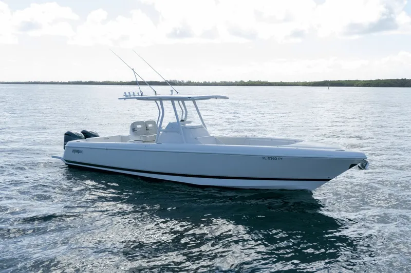 Slide: The Image of 2015 Intrepid 327 CC INFUSED boat on calm water, side view. - 3