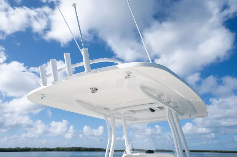 Slide: The Image of 2015 Intrepid 327 CC INFUSED boat top against blue sky and clouds. - 34