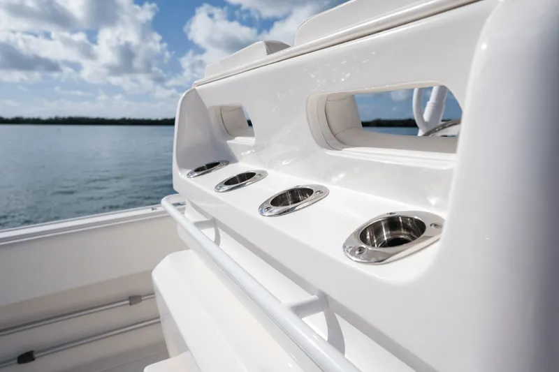 Slide: The Image of 2015 Intrepid 327 CC INFUSED boat detail with rod holders, ocean view. - 35