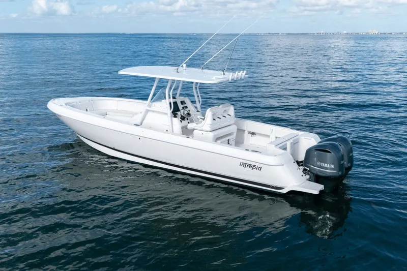 Slide: The Image of 2015 Intrepid 327 CC INFUSED boat on calm ocean waters. - 7