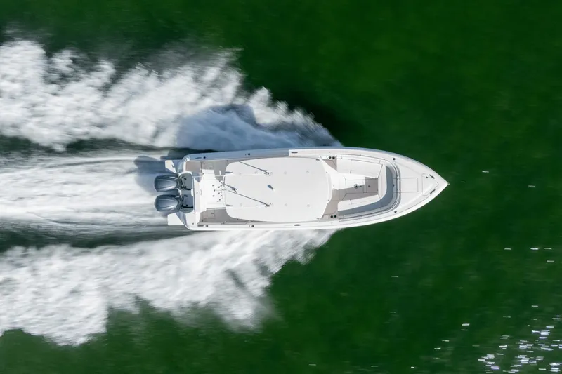 Slide: The Image of Aerial view of 2015 Intrepid 327 CC INFUSED boat speeding on water. - 8