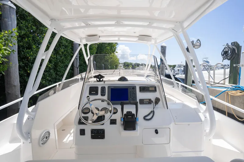 Slide: The Image of 2005 Intrepid 348 WA boat cockpit with steering wheel and navigation equipment. - 10