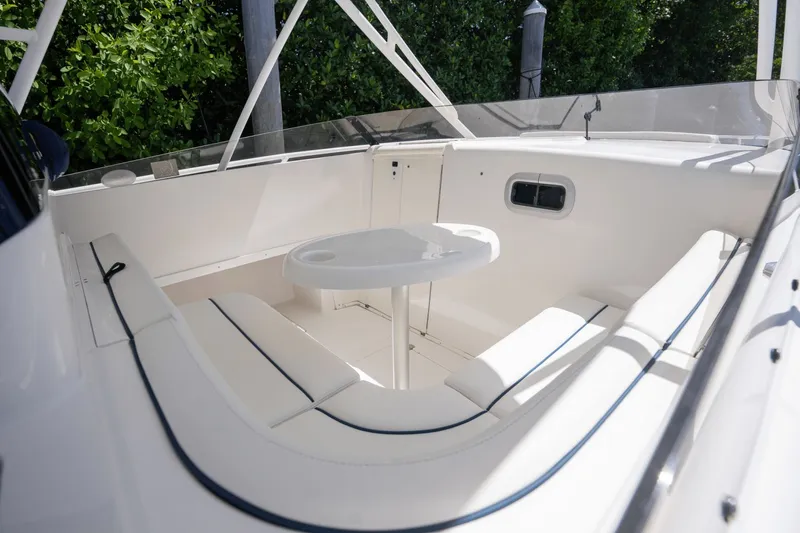 Slide: The Image of 2005 Intrepid 348 WA boat interior with white seating and table. - 11