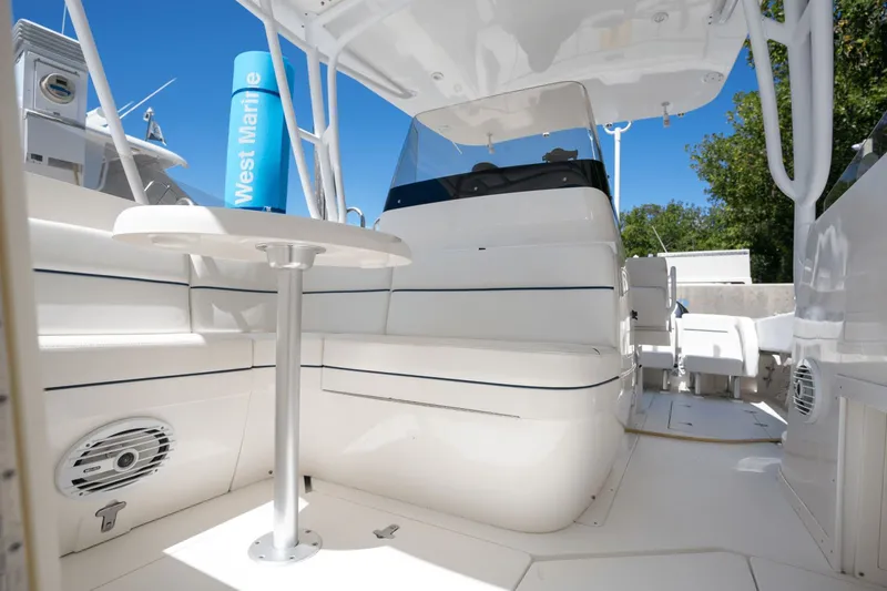 Slide: The Image of 2005 Intrepid 348 WA boat interior with seating and table, showcasing sleek design. - 16