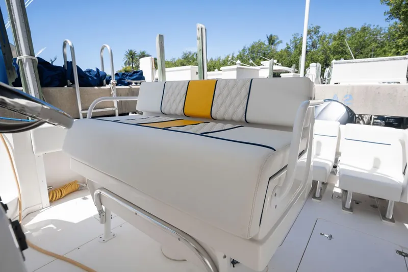 Slide: The Image of 2005 Intrepid 348 WA boat interior with white and yellow seating, sunny day. - 17