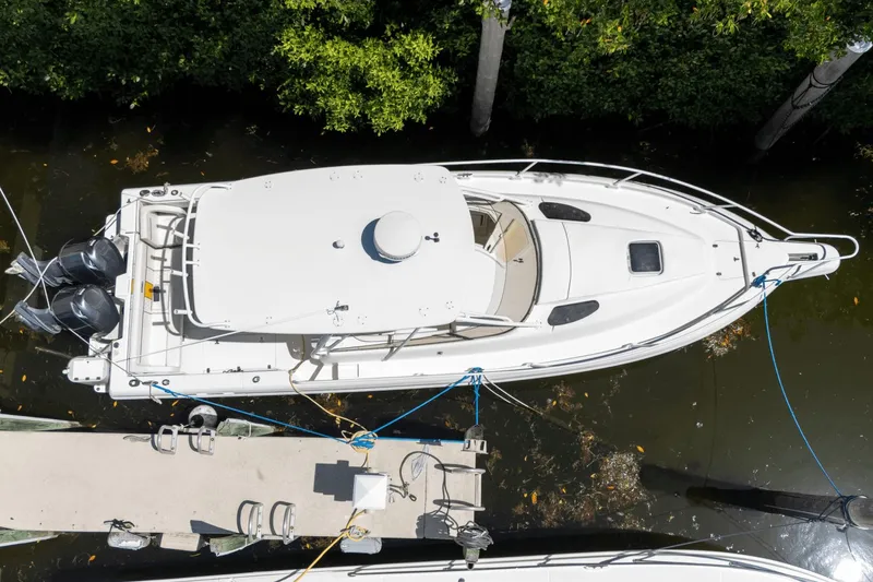 Slide: The Image of Aerial view of 2005 Intrepid 348 WA boat docked by greenery. - 2