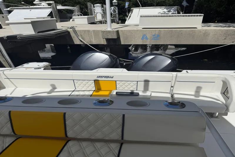 Slide: The Image of 2005 Intrepid 348 WA boat with dual engines, docked at a marina. - 21