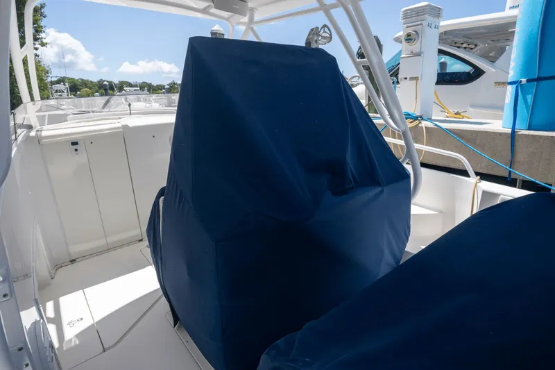 Slide: The Image of 2005 Intrepid 348 WA boat interior with covered seating, docked under clear skies. - 5