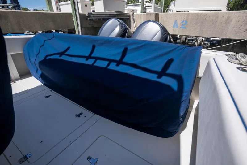 Slide: The Image of 2005 Intrepid 348 WA boat with covered seating and dual outboard motors. - 6