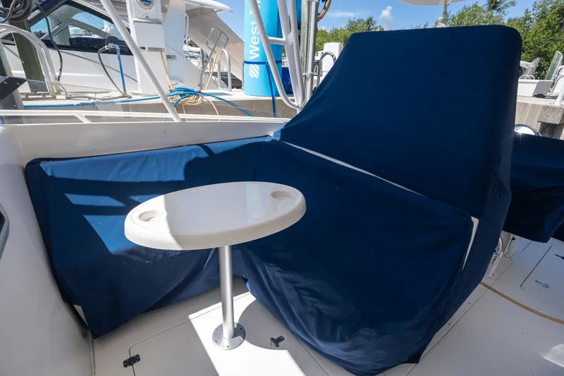 Slide: The Image of 2005 Intrepid 348 WA boat interior with blue seating and a small round table. - 7