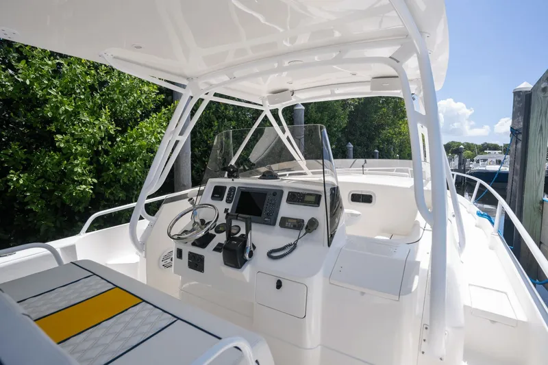 Slide: The Image of 2005 Intrepid 348 WA boat cockpit with steering wheel, navigation controls, and seating. - 8