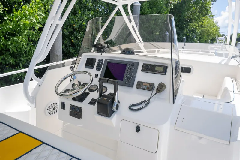 Slide: The Image of 2005 Intrepid 348 WA boat helm with steering wheel, navigation controls, and communication equipment. - 9