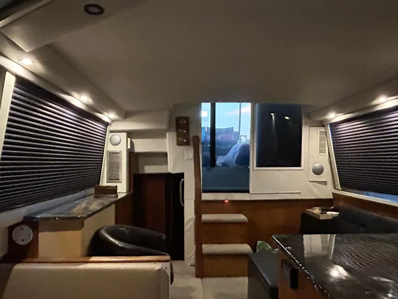 Slide: The Image of Interior of 1994 Carver 390 Cockpit Motor Yacht with modern seating and ambient lighting. - 4