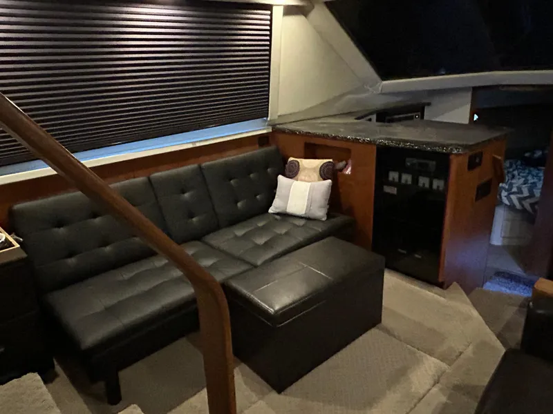 Slide: The Image of Luxurious interior of 1994 Carver 390 Cockpit Motor Yacht with black leather seating. - 3