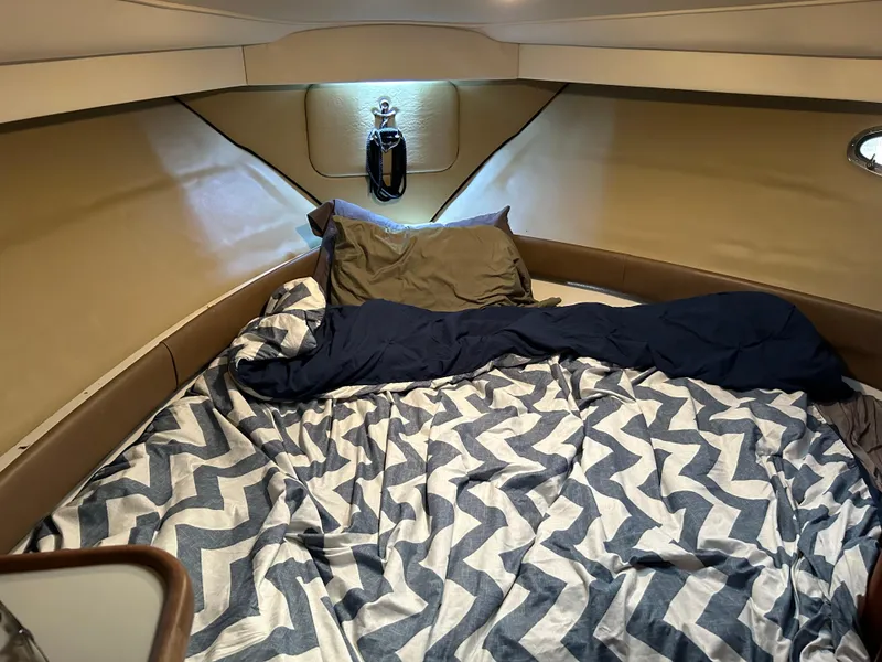 Slide: The Image of Cozy cabin interior of 1994 Carver 390 Cockpit Motor Yacht with patterned bedding. - 6