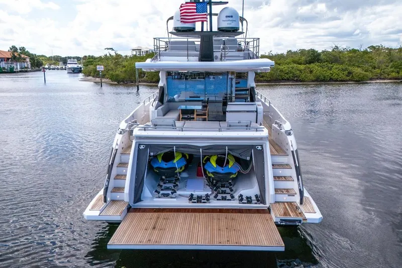 Slide: The Image of Azimut S7 FLY 2020 yacht with open garage, jet skis, and American flag. - 12