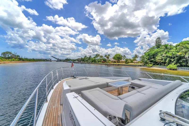 Slide: The Image of Luxurious 2020 Azimut S7 FLY yacht cruising on a scenic river under a vibrant sky. - 17