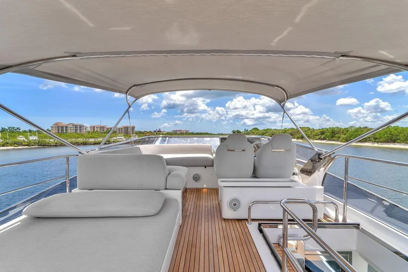 Slide: The Image of Luxurious 2020 Azimut S7 FLY yacht deck with seating, under a canopy, cruising on a sunny day. - 19