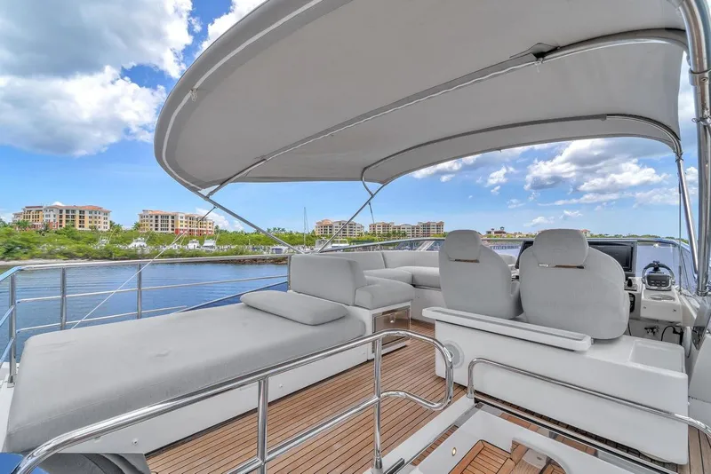 Slide: The Image of Luxurious 2020 Azimut S7 FLY yacht deck with seating, overlooking waterfront buildings. - 20