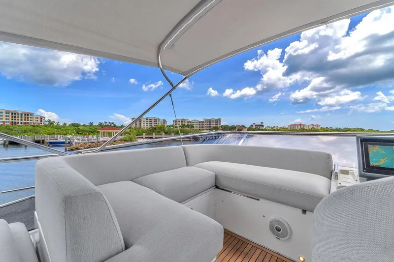 Slide: The Image of Azimut S7 FLY 2020 yacht interior with plush seating and scenic waterfront view. - 21