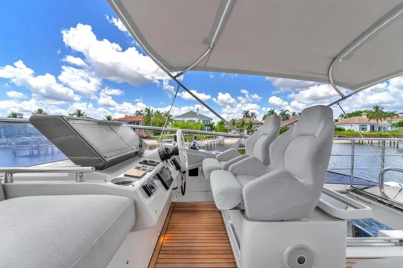 Slide: The Image of Flybridge of 2020 Azimut S7 FLY yacht with luxurious seating and scenic waterfront view. - 22