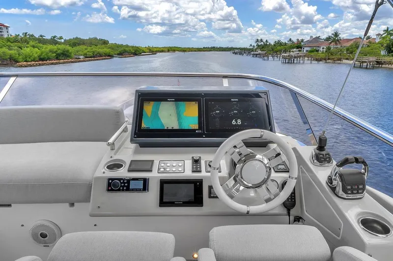 Slide: The Image of Cockpit view of 2020 Azimut S7 FLY yacht with navigation screens and steering wheel. - 24