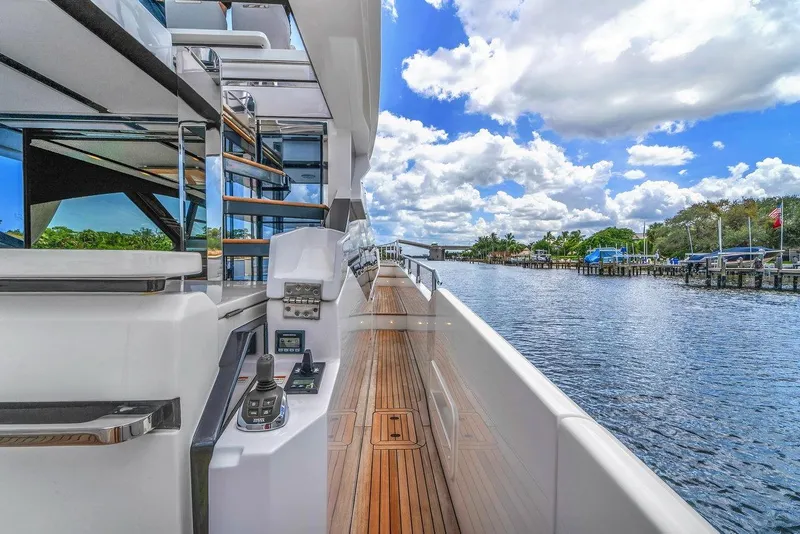 Slide: The Image of 2020 Azimut S7 FLY yacht with sleek design, docked by a scenic waterfront. - 28