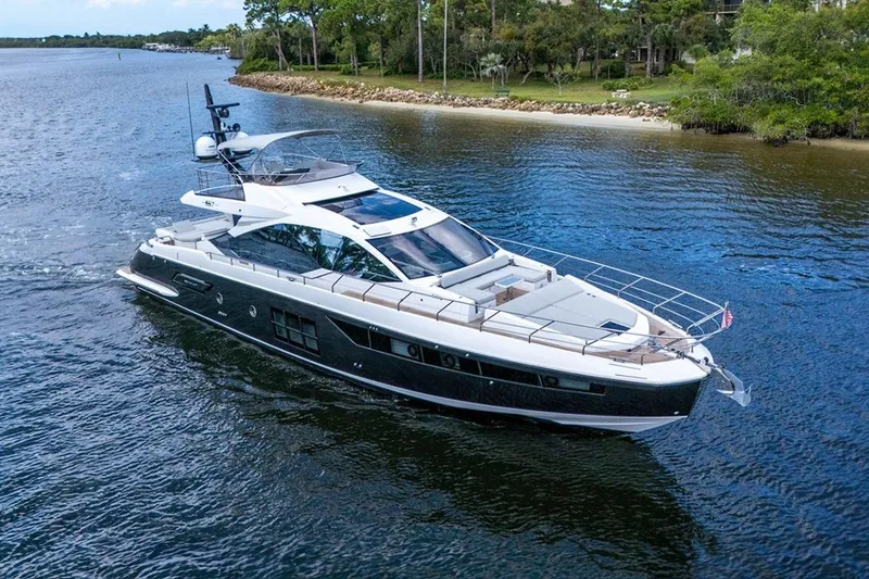 Slide: The Image of Luxurious 2020 Azimut S7 FLY yacht cruising on a serene waterway. - 3