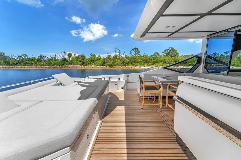 Slide: The Image of Luxurious 2020 Azimut S7 FLY yacht deck with sun loungers and dining area. - 32