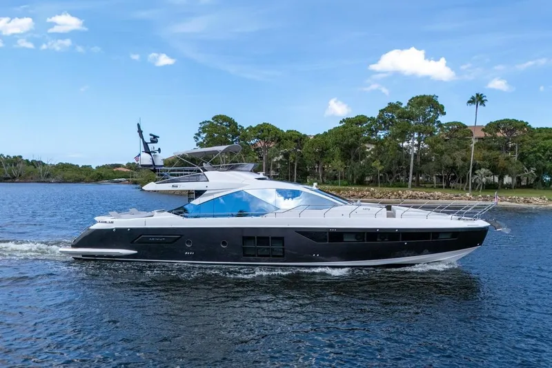 Slide: The Image of Luxury 2020 Azimut S7 FLY yacht cruising on a scenic waterway. - 4