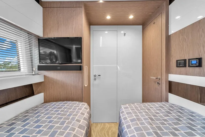 Slide: The Image of Luxurious 2020 Azimut S7 FLY yacht cabin with twin beds and modern amenities. - 67