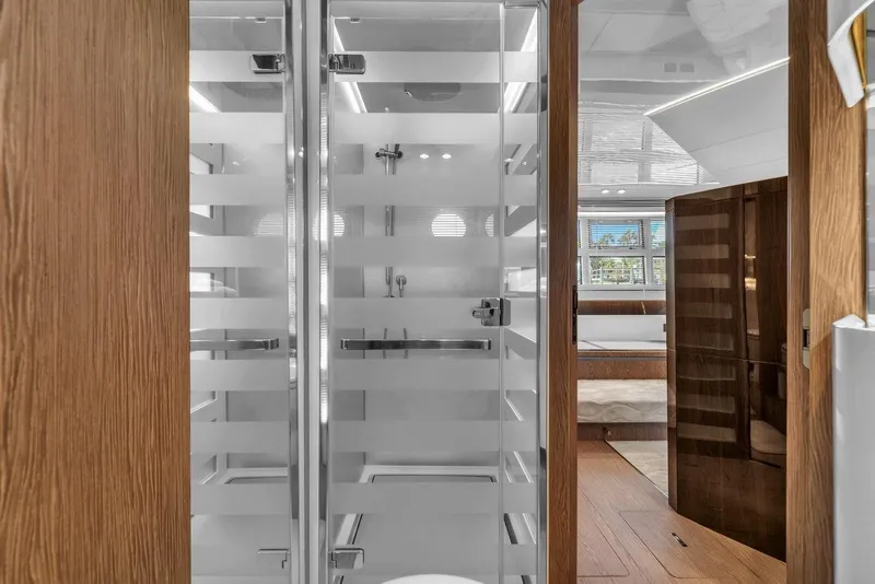 Slide: The Image of Luxurious interior of 2020 Azimut S7 FLY yacht featuring modern shower and elegant wood finishes. - 77