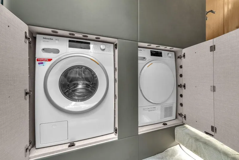 Slide: The Image of Laundry appliances in Azimut S7 FLY 2020 yacht, featuring Miele washer and dryer. - 79