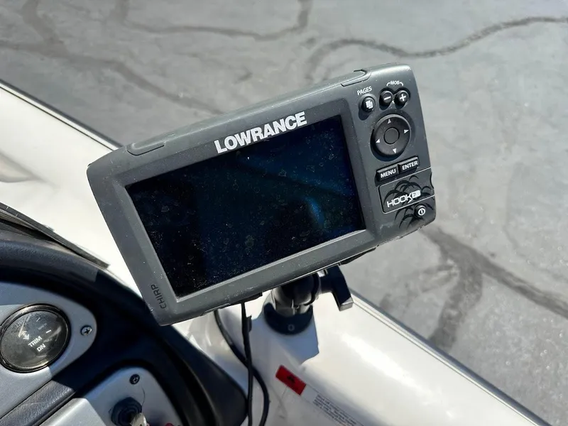 Slide: The Image of Lowrance Hook fish finder on 2004 Stratos 285 PRO XL DC boat dashboard. - 18