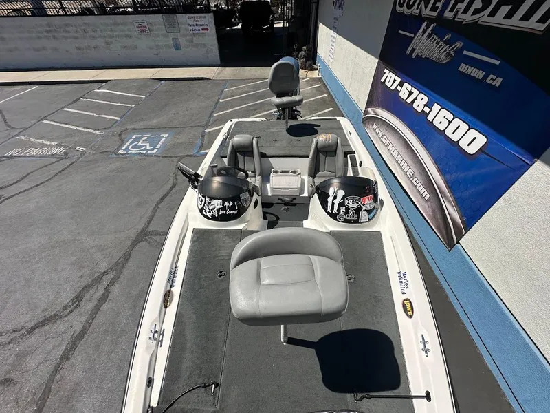 Slide: The Image of 2004 Stratos 285 PRO XL DC boat in parking lot, featuring seating and control panel. - 24