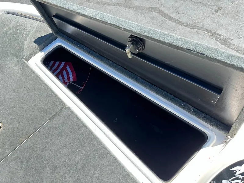 Slide: The Image of Open storage compartment on 2004 Stratos 285 PRO XL DC boat with American flag inside. - 25
