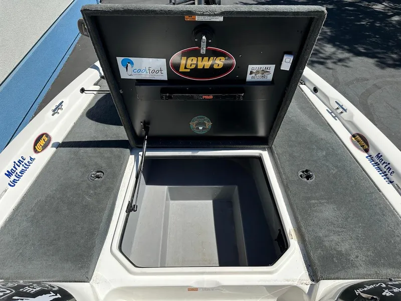 Slide: The Image of 2004 Stratos 285 PRO XL DC boat storage compartment with Lew's and Marine Unlimited stickers. - 27
