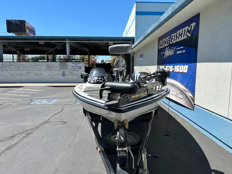 Slide: The Image of 2004 Stratos 285 PRO XL DC boat on trailer, parked outside a fishing store. - 3