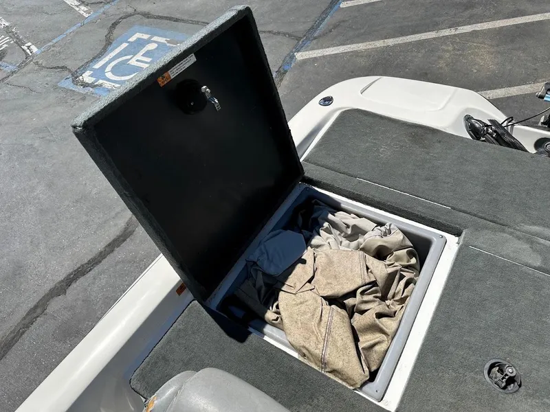 Slide: The Image of Open storage compartment on 2004 Stratos 285 PRO XL DC boat, containing fabric items. - 32