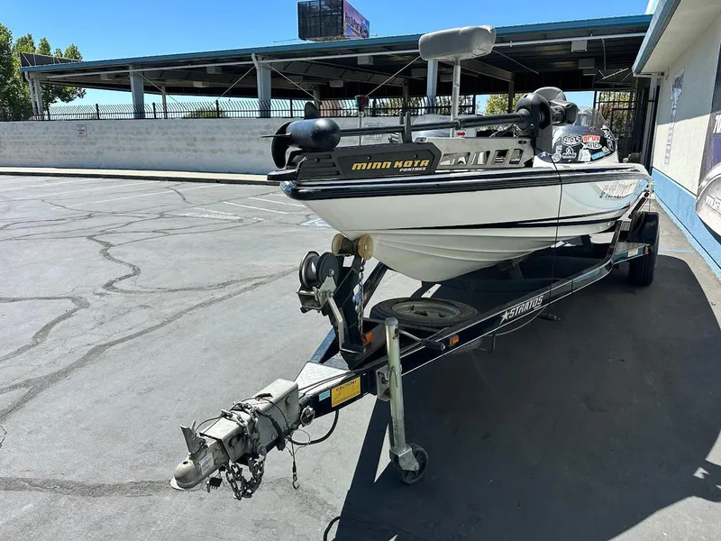 Slide: The Image of 2004 Stratos 285 PRO XL DC boat on trailer in parking lot. - 4