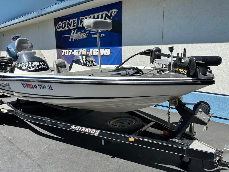 Slide: The Image of 2004 Stratos 285 PRO XL DC boat on trailer, parked outside a marine shop. - 5