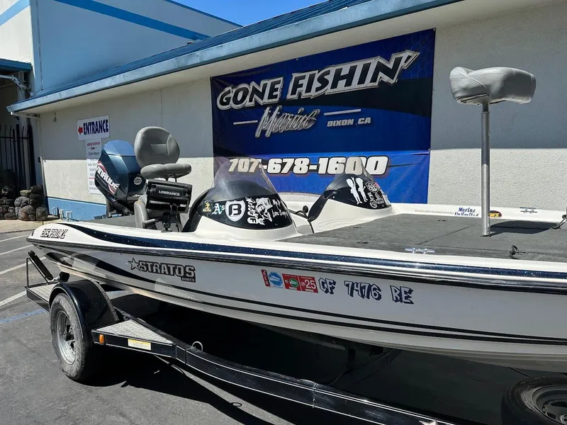 Slide: The Image of 2004 Stratos 285 PRO XL DC boat parked outside a fishing store. - 6