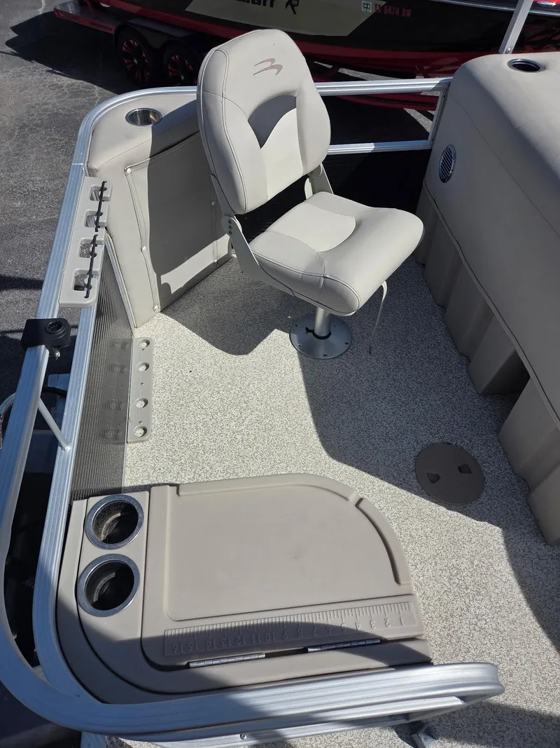 Slide: The Image of 2019 Bennington SV 188 SFV boat interior with beige seating and cup holders. - 8