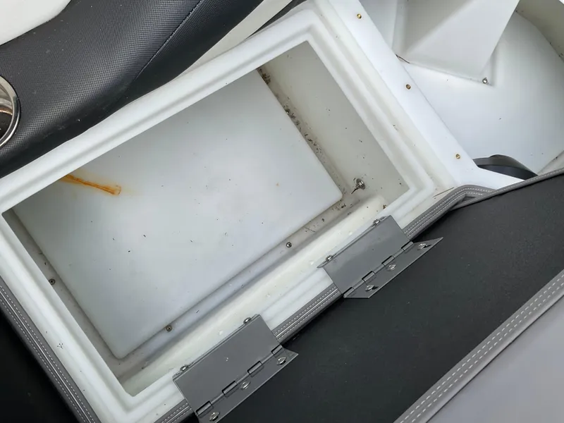 Slide: The Image of Open storage compartment in 2019 Sylvan SE-CRS25 boat, showing interior details. - 19