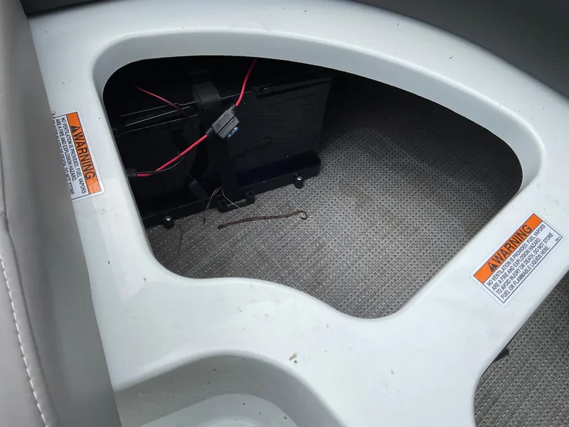 Slide: The Image of Battery compartment of a 2019 Sylvan SE-CRS25 boat with warning labels. - 21