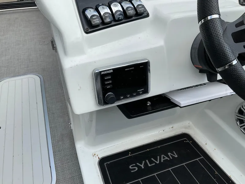 Slide: The Image of 2019 Sylvan SE-CRS25 boat dashboard with controls and steering wheel. - 25