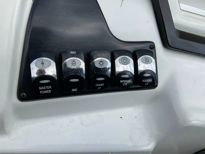 Slide: The Image of Control panel of a 2019 Sylvan SE-CRS25 boat with labeled switches. - 26