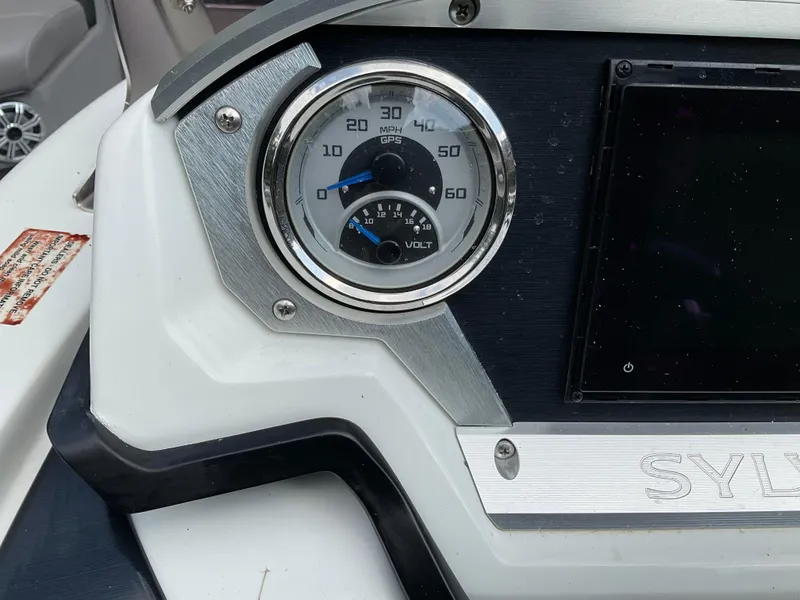 Slide: The Image of Dashboard of a 2019 Sylvan SE-CRS25 boat with speedometer and voltmeter. - 30