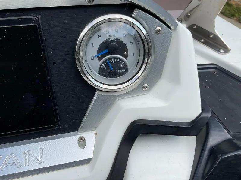 Slide: The Image of Dashboard of 2019 Sylvan SE-CRS25 boat showing RPM and fuel gauges. - 32